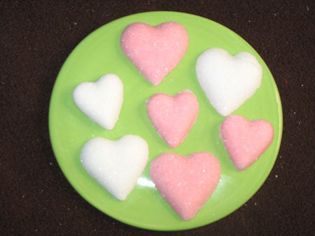 Tea sugars shaped in two sizes of pink and white hearts