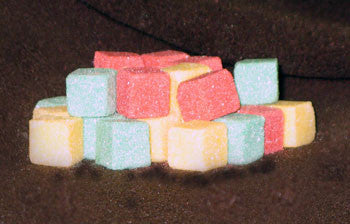 Mini-sized sugar cubes in red, green, and gold
