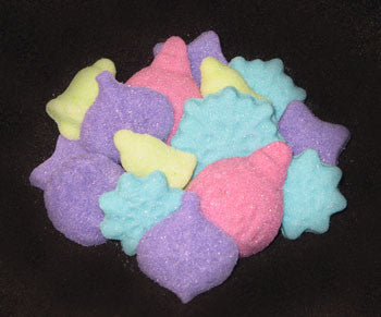Tea sugars shaped like snowflakes, bells, and ornaments in fuchsia, turquoise, lime, and purple 